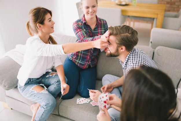 Content friends having fun with playing cards