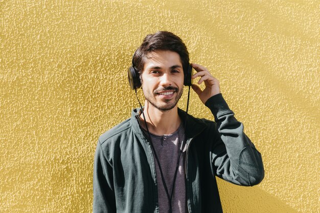 Content man posing in earphones