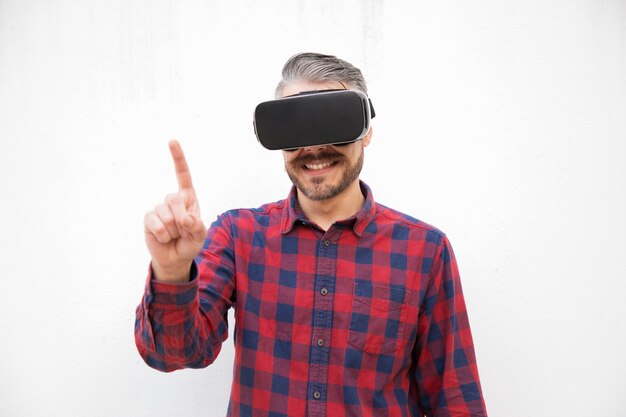 Content man in VR headset pointing with finger