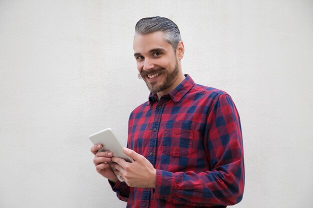 Content man with digital tablet smiling