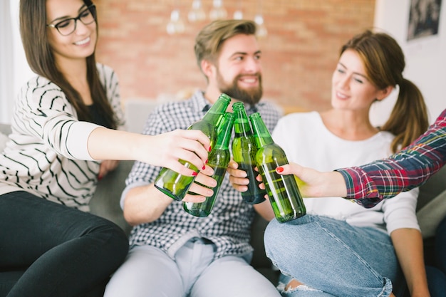 Content people clinking with beer bottles