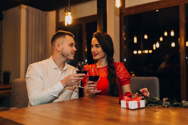 Content people clinking with glasses in cafe