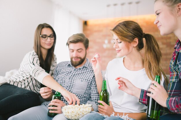 Content people enjoying beers with snack