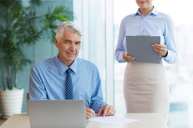 Content Senior Boss Signing Document and Secretary