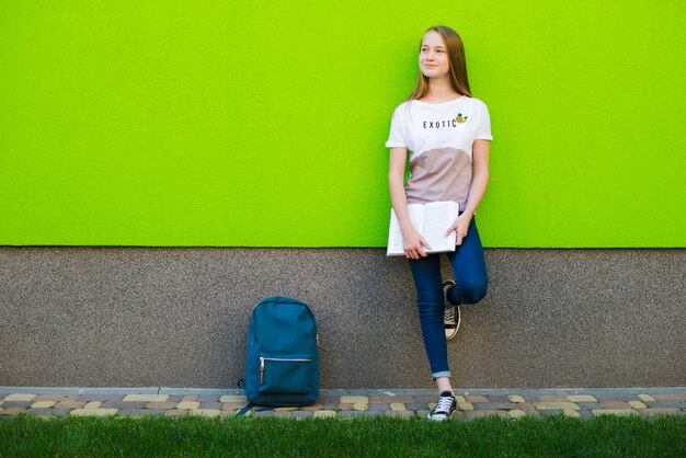 Content student with textbook outside