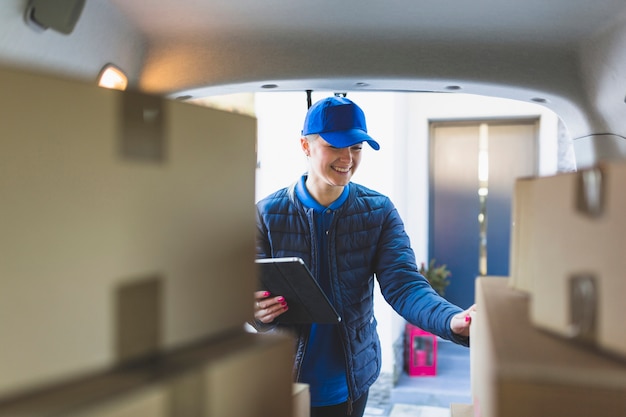 Free photo content woman delivering ordered parcels