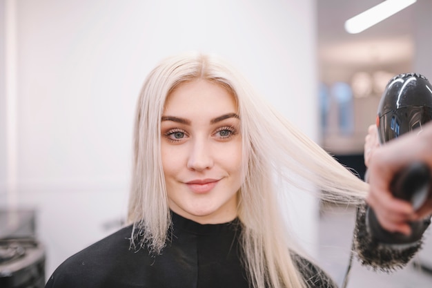 Content woman enjoying salon hairstyle