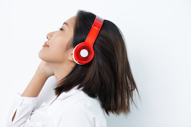 Content Woman in Headphones Listening to Music