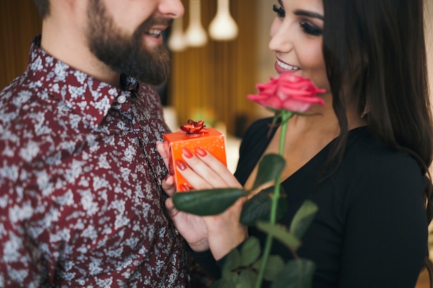 Content woman making present for man