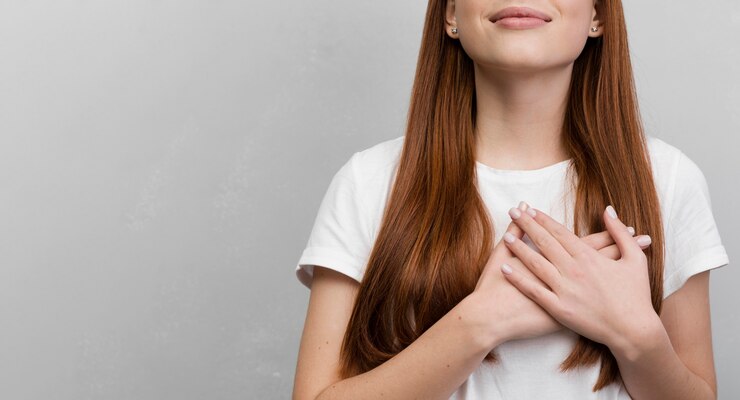 Free Photo content woman with hands on chest
