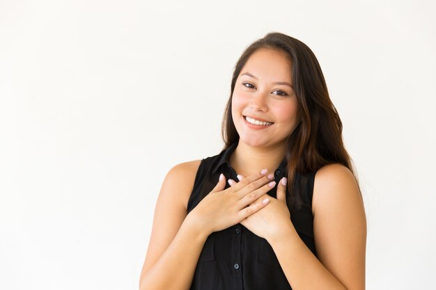 Content woman with hands on chest