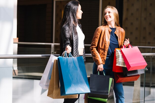 Content women walking in shopping center