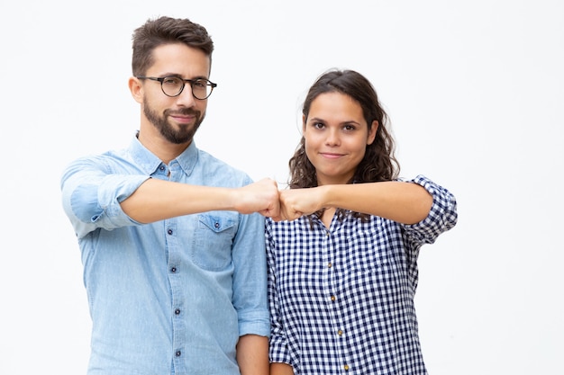 Free photo content young couple touching fists