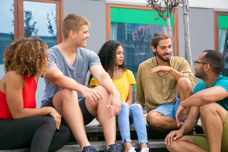 Free Photo content young friends sitting on steps