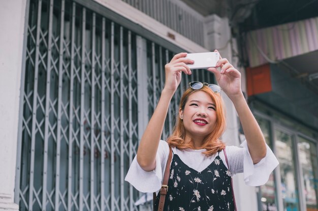 思い出に残る写真を撮っているコンテンツの若い女性