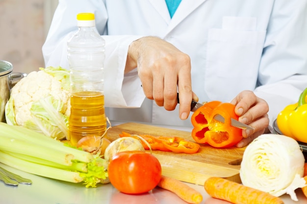 cook cuts  pepper on cutting board