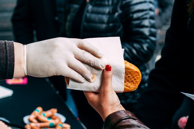 Cook gives hot dog to girl