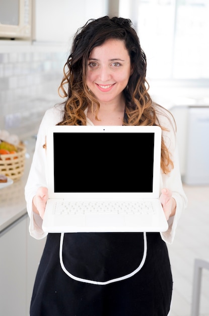 Free photo cook presenting laptop