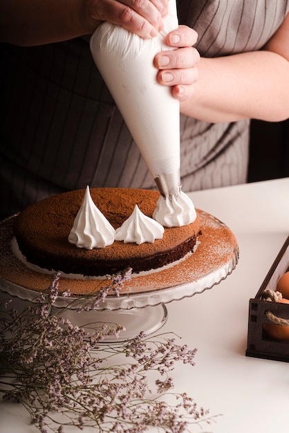 Cook putting icing decorations on cake