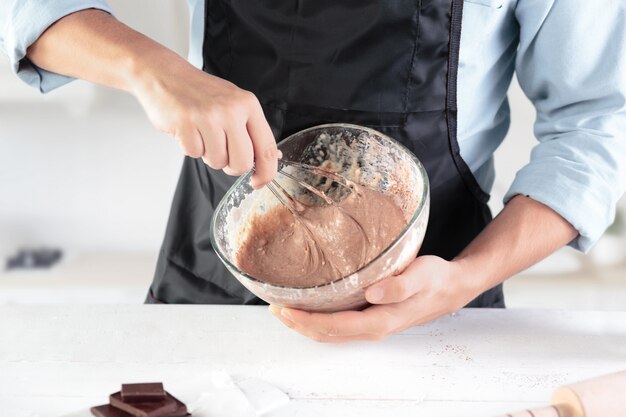 男性の手の背景に素朴なキッチンで卵料理