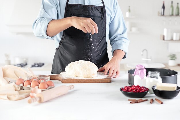 A cook with eggs on a rustic kitchen of men's hands