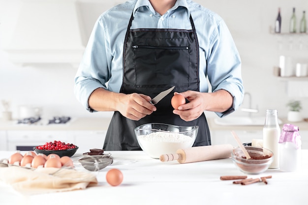 A cook with eggs on a rustic kitchen