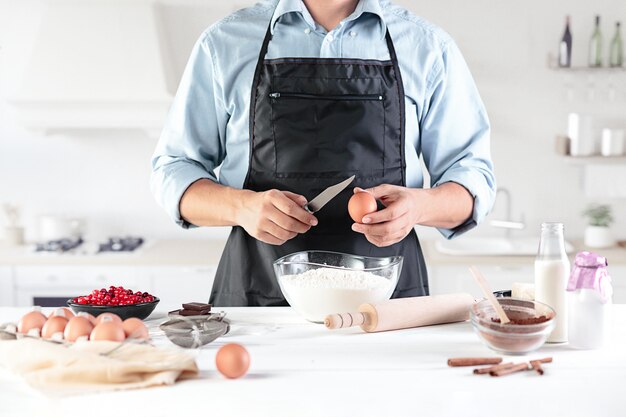 A cook with eggs on a rustic kitchen