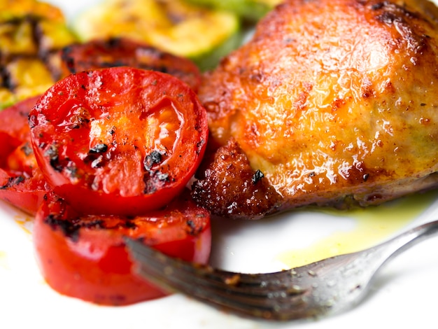 Cooked chicken legs with tomatos