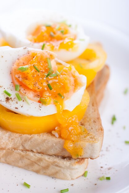 Cooked eggs on slice of bread