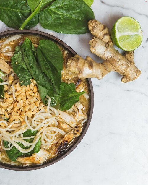 Cooked food served on platter with ginger and lemon