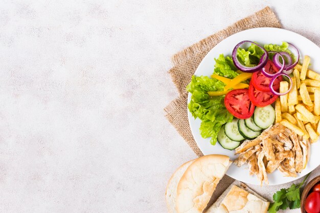 Cooked meat and veggies kebab in white plate