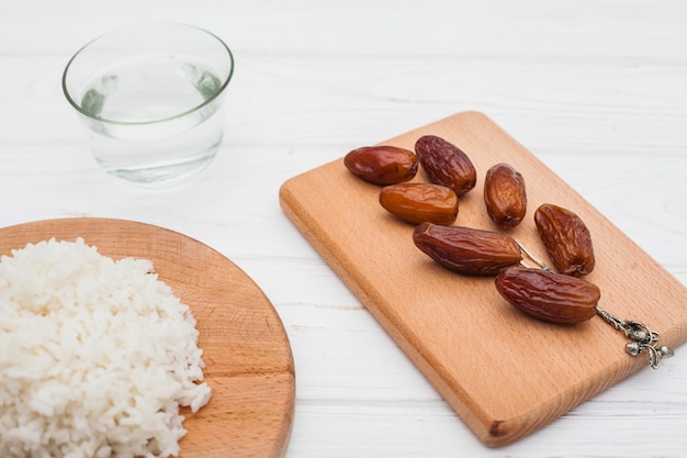 Cooked rice with dates fruit on board 