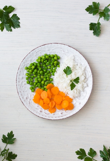 Cooked rice with vegetables and parsley on plate 