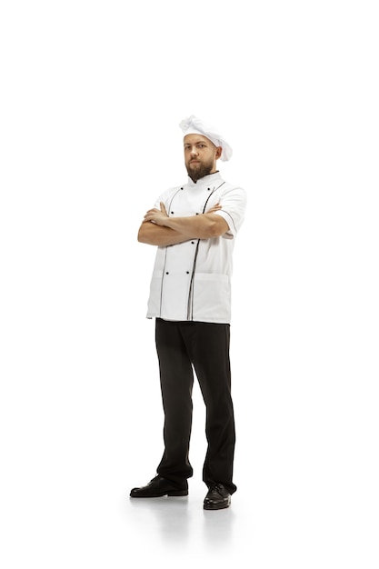 Free photo cooker, chef, baker in uniform isolated on white studio background, gourmet. young man, restaurant cooker's portrait. business, foor, professional occupation, emotions concept. copyspace for ad.