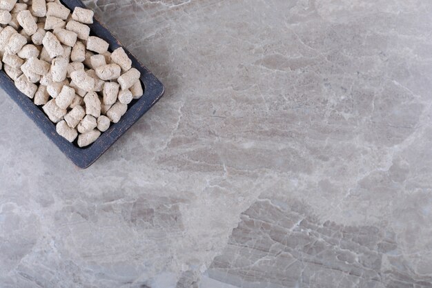 Cookie crumbs in the tray, on the marble surface