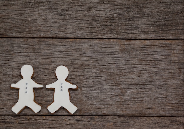 Free photo cookie with person shape on a wooden table