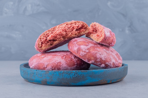 Cookies bundled up on a small blue platter on marble