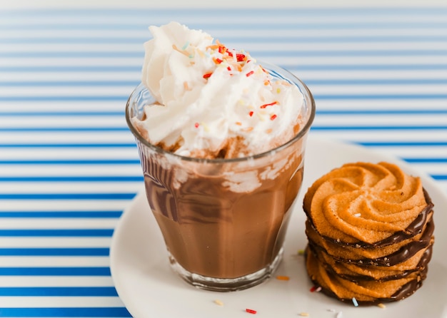 Cookies and cup of espresso coffee with chocolate and whipped cream