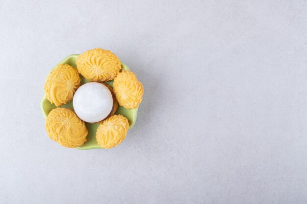 Cookies and glazed biscuit in a bowl, on the marble.