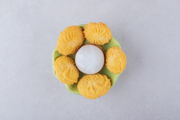 Cookies and glazed biscuit in a bowl, on the marble.