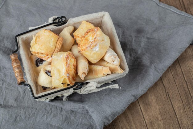 Cookies on metallic container on white towel.