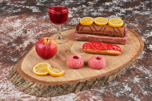 Cookies and rollcake on a wooden board.