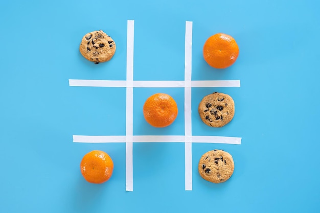 Cookies and tangerines on a blue background flat lay