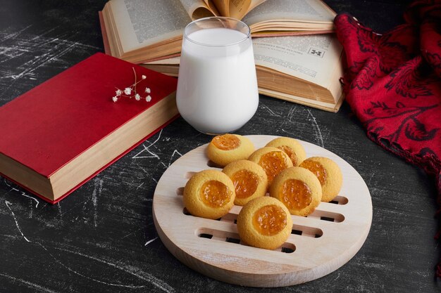 Cookies with citrus fruit jam and a glass of milk. 