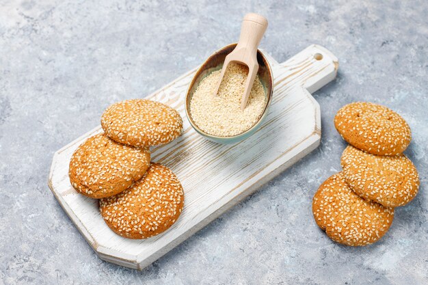 Cookies with sesame seeds on concrete surface,top view