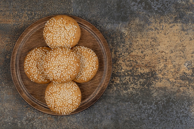 Free photo cookies with sesame seeds on wooden board.