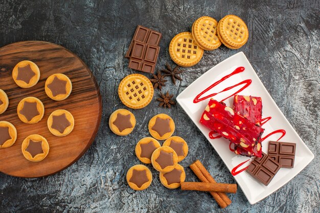 cookies on wooden platter and a plate of chocolate on grey