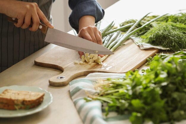 Cooking. Chef is cutting greens in the kitchen