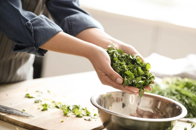 Cooking. Chef is cutting greens in the kitchen