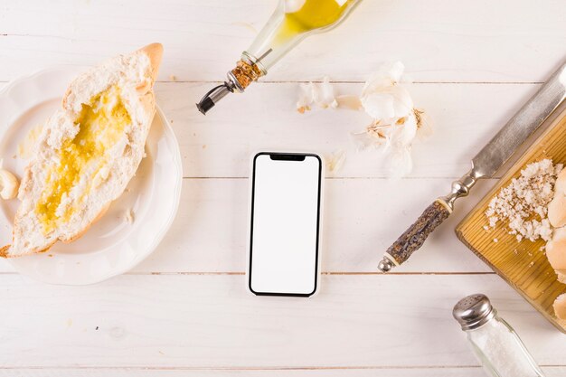 Cooking desk with bread and smartphone 